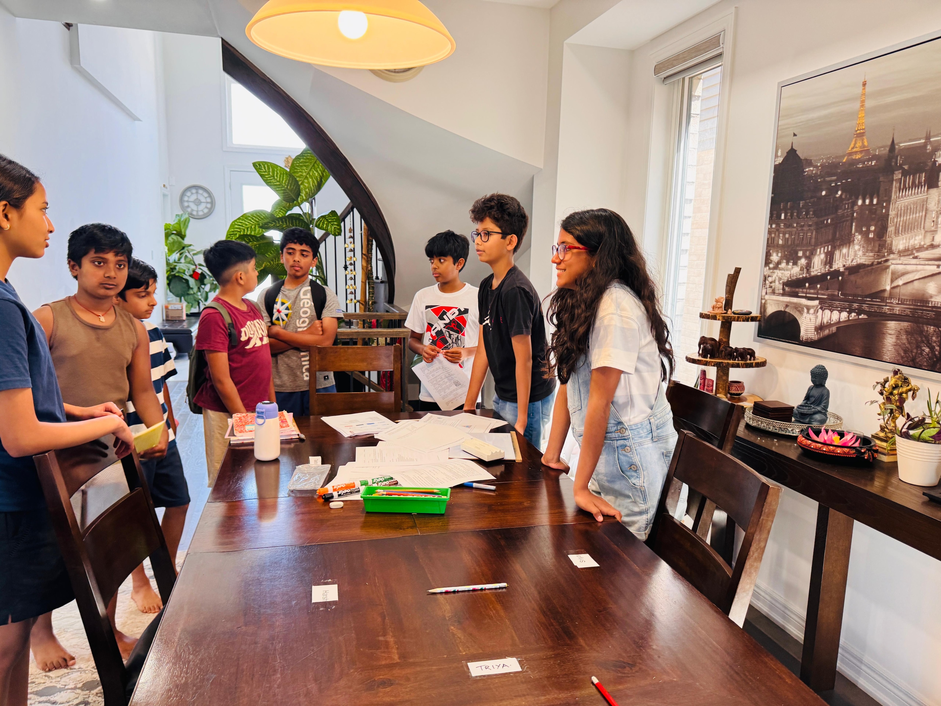 Students gathered around the classroom table during a session