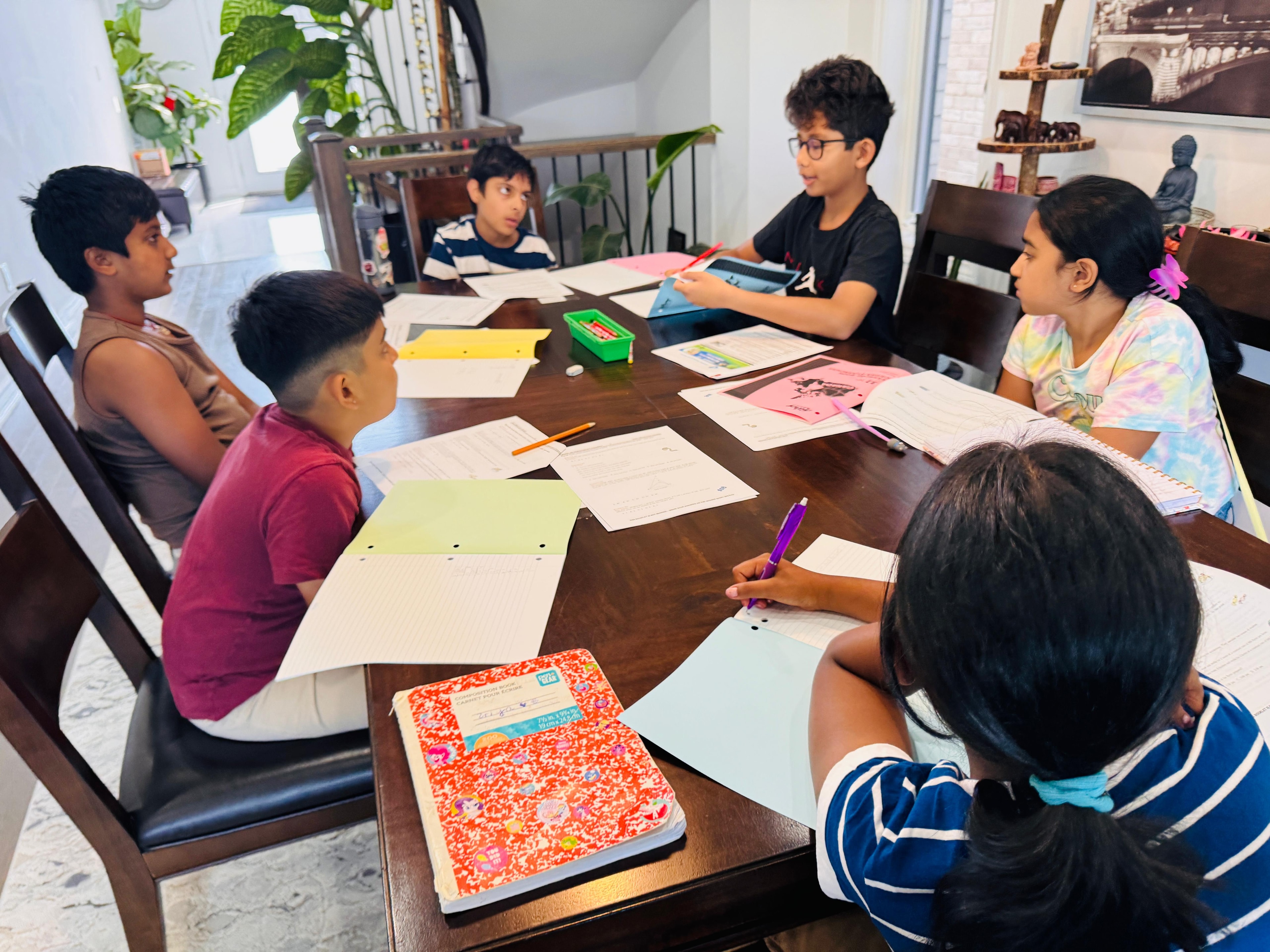 Students engaged in problem-solving at the dining table