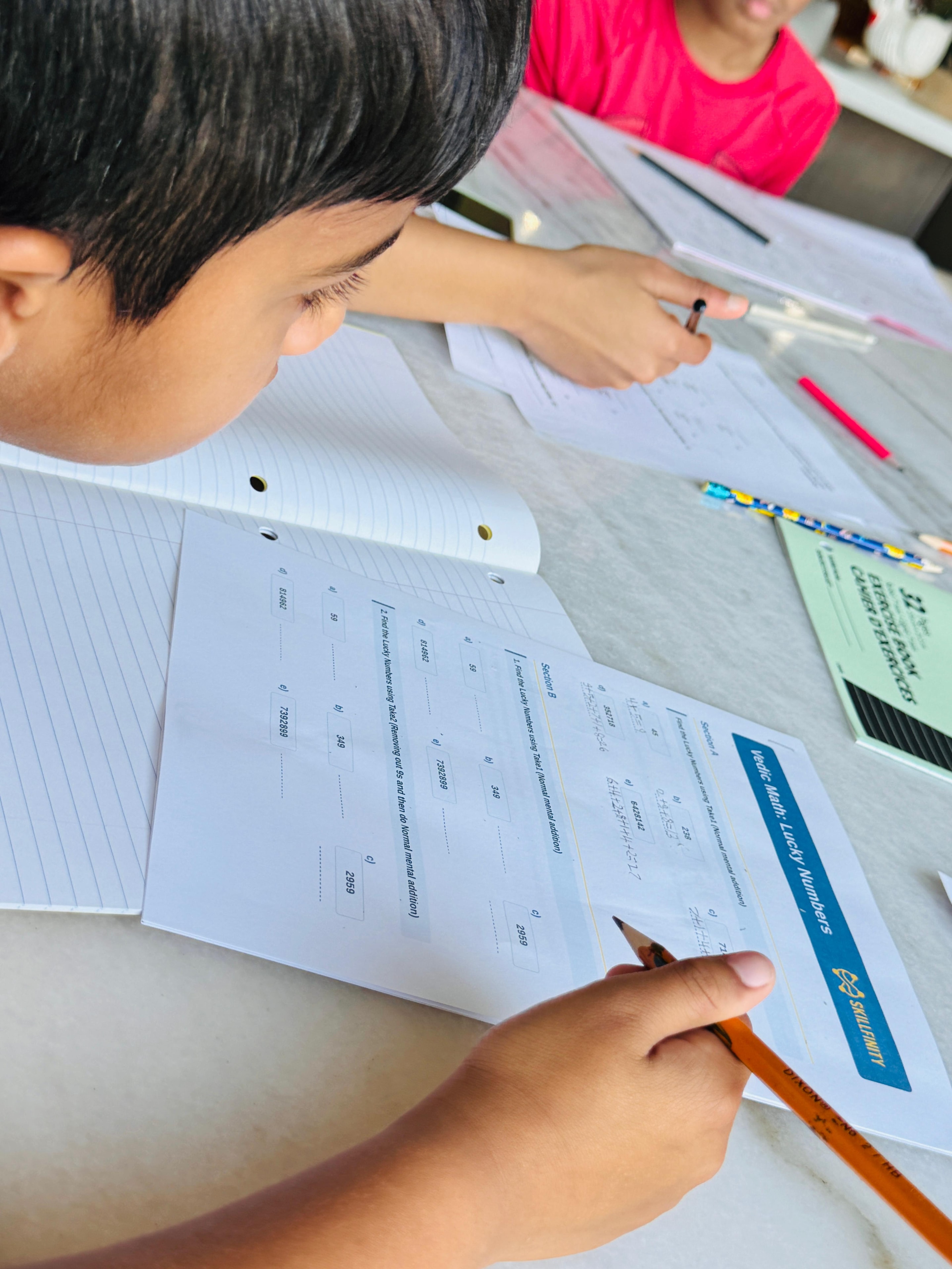 Close-up of a student working through a Vedic Math worksheet